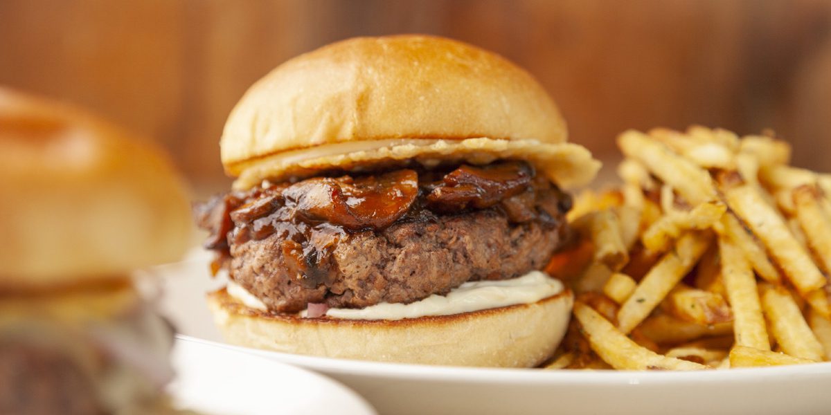 Umami Burger and Fries on a white plate